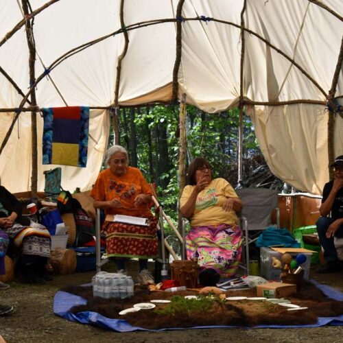 people sitting in a tent