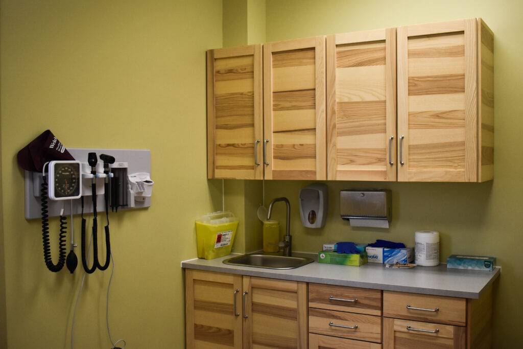 a room with sink, cabinets and medical equipments
